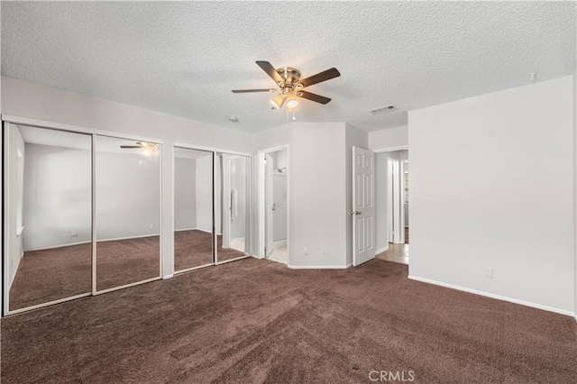 38115 41st St E, Palmdale, CA 93552 - unfurnished bedroom with two closets, carpet, a textured ceiling, baseboards, and a ceiling fan