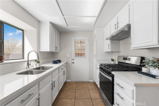 38115 41st St E, Palmdale, CA 93552 - kitchen with stainless steel range with gas cooktop, under cabinet range hood, a sink, white cabinets, and tile patterned floors