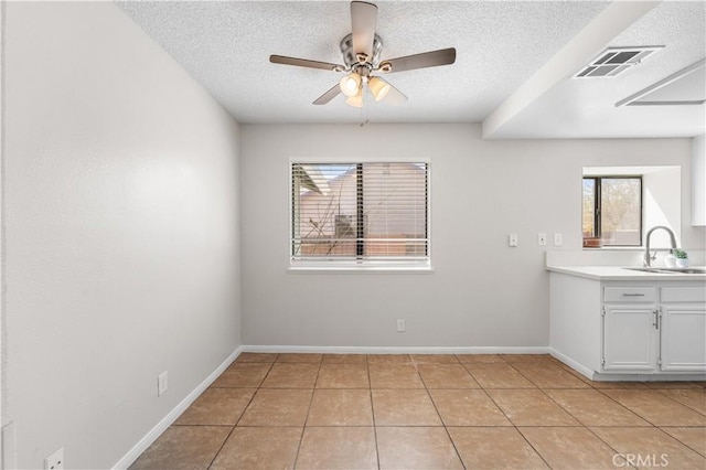 38115 41st St E, Palmdale, CA 93552 - unfurnished dining area with a sink, a textured ceiling, ceiling fan, healthy amount of natural light, and light tile patterned floors