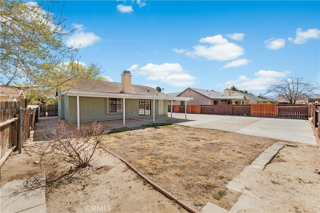 38115 41st St E, Palmdale, CA 93552 - rear view of house with a patio area, a fenced backyard, and a chimney