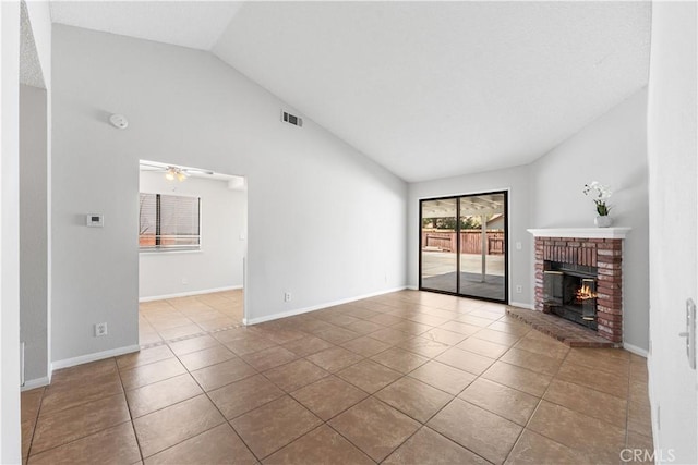 38115 41st St E, Palmdale, CA 93552 - unfurnished living room with lofted ceiling, a brick fireplace, tile patterned flooring, a ceiling fan, and baseboards
