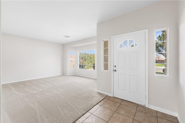 43453 Tali St, Lancaster, CA 93535 - entrance foyer with baseboards, light tile patterned floors, and light colored carpet