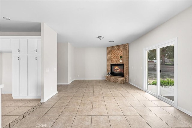 43453 Tali St, Lancaster, CA 93535 - unfurnished living room featuring light tile patterned floors, a brick fireplace, and baseboards