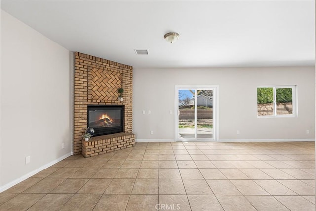 43453 Tali St, Lancaster, CA 93535 - unfurnished living room featuring light tile patterned floors, plenty of natural light, a fireplace, and baseboards