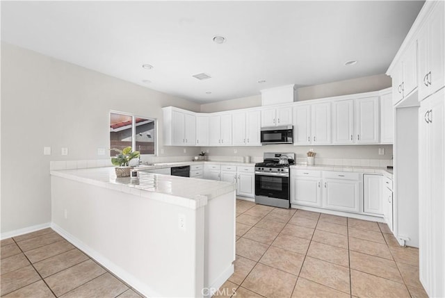 43453 Tali St, Lancaster, CA 93535 - kitchen featuring appliances with stainless steel finishes, a peninsula, light tile patterned floors, white cabinetry, and recessed lighting