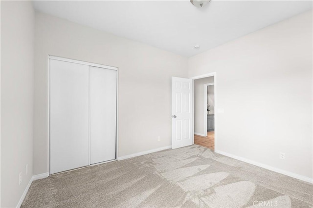 43453 Tali St, Lancaster, CA 93535 - unfurnished bedroom featuring light carpet, baseboards, and a closet