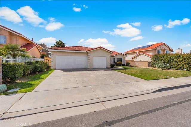 43453 Tali St, Lancaster, CA 93535 - view of front facade with stucco siding, a garage, a tiled roof, and concrete driveway