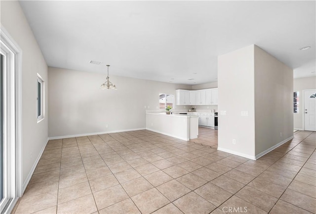 43453 Tali St, Lancaster, CA 93535 - unfurnished living room featuring light tile patterned flooring, a chandelier, and baseboards