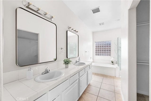 43453 Tali St, Lancaster, CA 93535 - bathroom featuring double vanity, a bath, a spacious closet, and tile patterned floors