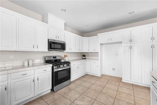 43453 Tali St, Lancaster, CA 93535 - kitchen with stainless steel appliances, white cabinetry, tile countertops, and recessed lighting