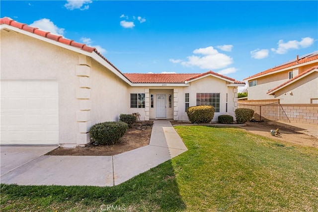 43453 Tali St, Lancaster, CA 93535 - mediterranean / spanish-style house featuring a tiled roof, stucco siding, and an attached garage