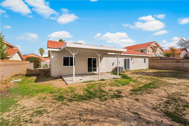 43453 Tali St, Lancaster, CA 93535 - back of house with stucco siding, a patio area, a fenced backyard, and central AC
