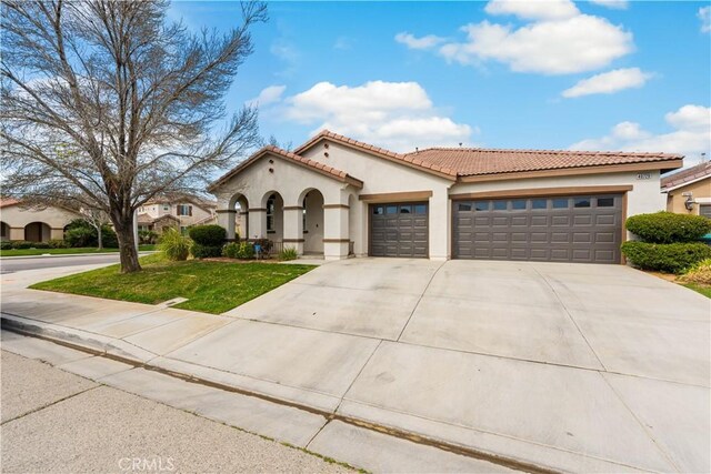 40729 Oakmont Ct, Palmdale, CA 93551 - mediterranean / spanish home featuring stucco siding, a garage, concrete driveway, a tile roof, and a front yard