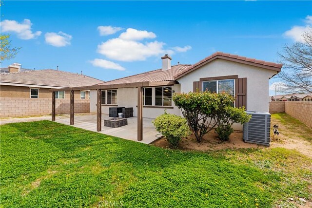 40729 Oakmont Ct, Palmdale, CA 93551 - back of house with cooling unit, a chimney, stucco siding, and a tile roof