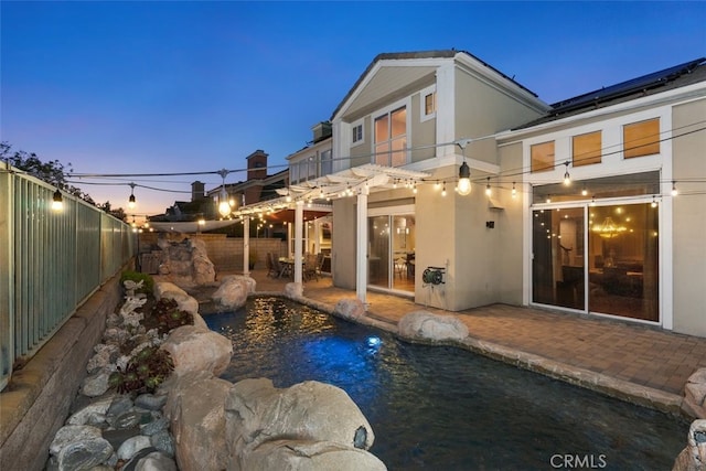 22581 Summerfield, Mission Viejo, CA 92692 - back of house featuring a balcony, stucco siding, a patio area, a fenced backyard, and solar panels