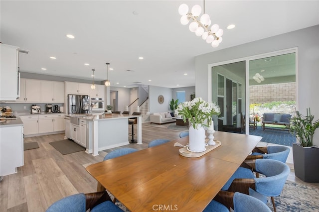 18171 Hedgerow Way, Saugus, CA 91350 - dining room featuring stairway, light wood-style flooring, and recessed lighting