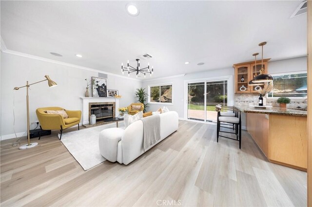 621 Foxhaven Pl, Diamond Bar, CA 91765 - living area featuring light wood-style floors, recessed lighting, a glass covered fireplace, baseboards, and crown molding