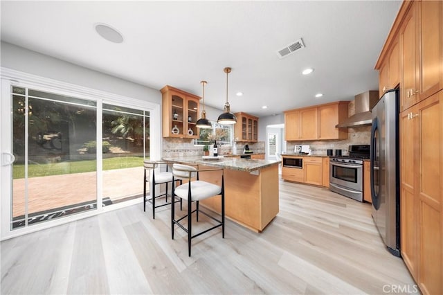 621 Foxhaven Pl, Diamond Bar, CA 91765 - kitchen featuring appliances with stainless steel finishes, glass insert cabinets, a breakfast bar area, backsplash, and light wood finished floors