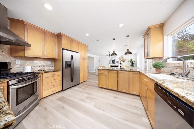 621 Foxhaven Pl, Diamond Bar, CA 91765 - kitchen with appliances with stainless steel finishes, wall chimney exhaust hood, a sink, light wood finished floors, and a peninsula