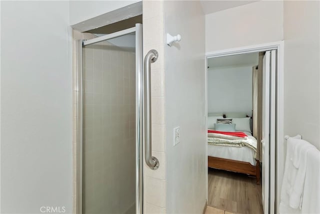 22771 Fir Ln, Crestline, CA 92325 - ensuite bathroom featuring a stall shower and wood finished floors