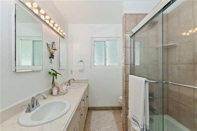 22771 Fir Ln, Crestline, CA 92325 - bathroom with double vanity, tile patterned flooring, toilet, and enclosed tub / shower combo
