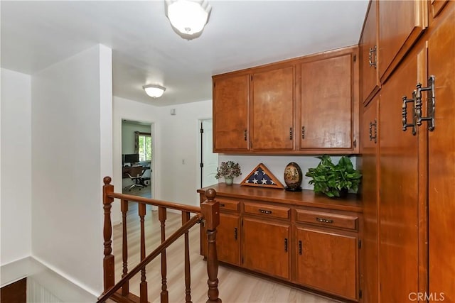 22771 Fir Ln, Crestline, CA 92325 - corridor with light wood-style floors and an upstairs landing