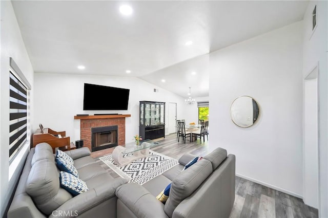 7035 Jon Allan Dr, North Hollywood, CA 91605 - living area with lofted ceiling, wood finished floors, a brick fireplace, a chandelier, and recessed lighting