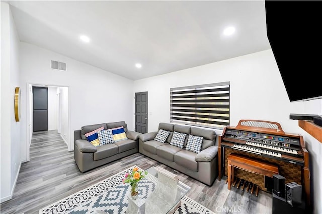 7035 Jon Allan Dr, North Hollywood, CA 91605 - living area with wood finished floors, lofted ceiling, baseboards, and recessed lighting