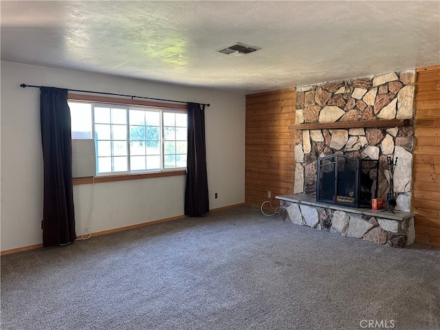 2378 Thisa Way, Hemet, CA 92544 - unfurnished living room featuring carpet, a textured ceiling, a stone fireplace, baseboards, and wooden walls