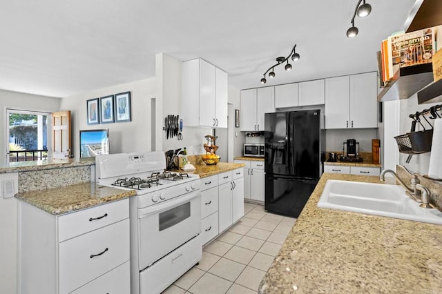 1529 Moreno St, Oceanside, CA 92054 - kitchen with black fridge with ice dispenser, white gas range oven, stainless steel microwave, a sink, and light tile patterned floors