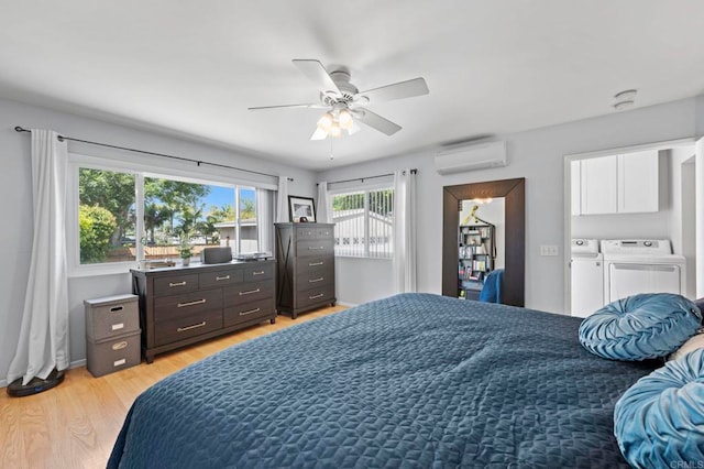 1529 Moreno St, Oceanside, CA 92054 - bedroom with a wall mounted AC, independent washer and dryer, light wood-style flooring, a ceiling fan, and baseboards