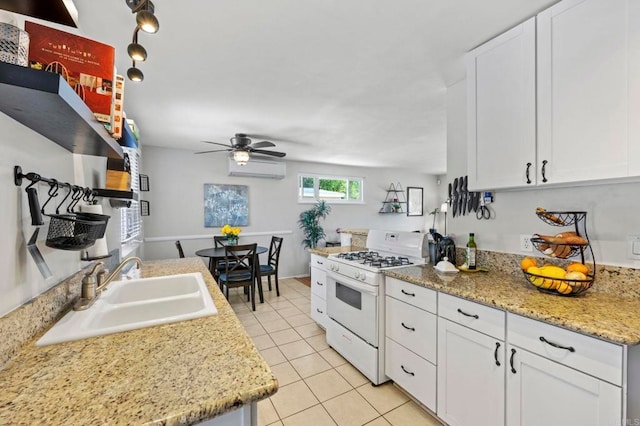 1529 Moreno St, Oceanside, CA 92054 - kitchen featuring gas range gas stove, a sink, a wall mounted air conditioner, a ceiling fan, and light tile patterned flooring