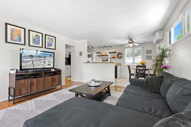 1529 Moreno St, Oceanside, CA 92054 - living area with an AC wall unit, ceiling fan, wood finished floors, and baseboards
