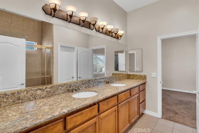 17322 Danbury Ave, Hesperia, CA 92345 - full bath with double vanity, a shower stall, and tile patterned floors