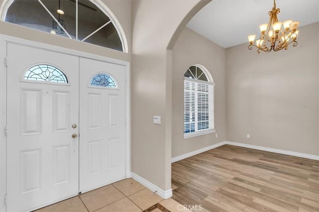 17322 Danbury Ave, Hesperia, CA 92345 - foyer entrance with arched walkways, a chandelier, healthy amount of natural light, and light wood-style floors