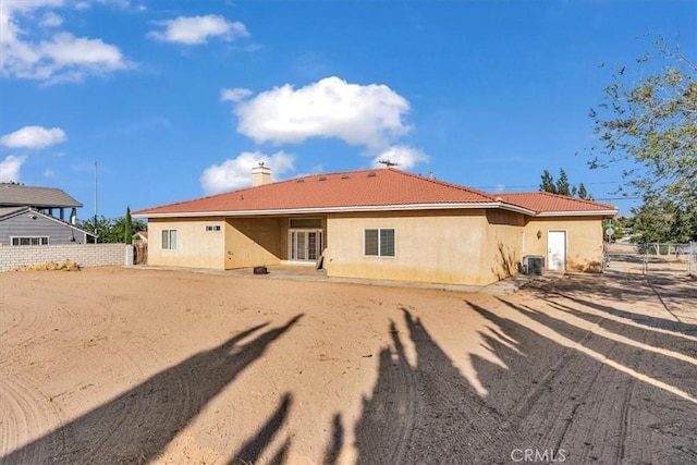 17322 Danbury Ave, Hesperia, CA 92345 - rear view of house with stucco siding, a tile roof, and a chimney