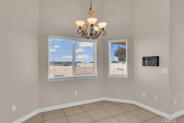 17322 Danbury Ave, Hesperia, CA 92345 - unfurnished dining area featuring a chandelier, a high ceiling, and light tile patterned floors