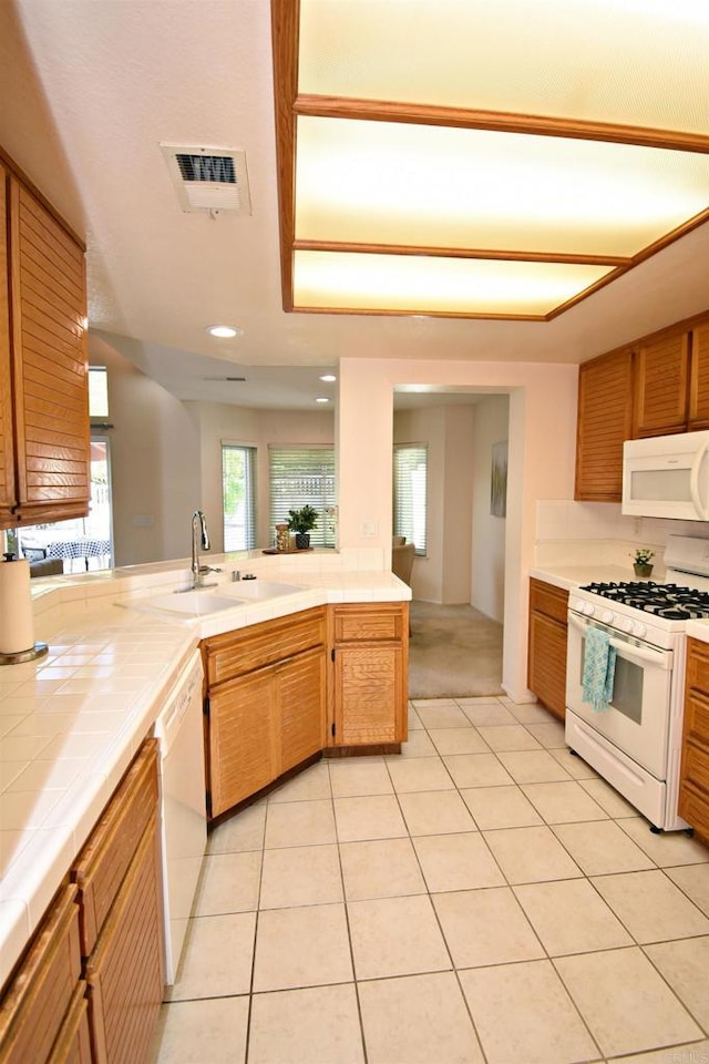 10908 Avenida Playa Veracruz, San Diego, CA 92124 - kitchen featuring white appliances, tile counters, a sink, light tile patterned flooring, and recessed lighting