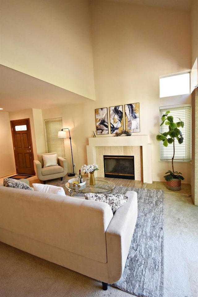 10908 Avenida Playa Veracruz, San Diego, CA 92124 - living area featuring carpet flooring, a tiled fireplace, and a high ceiling