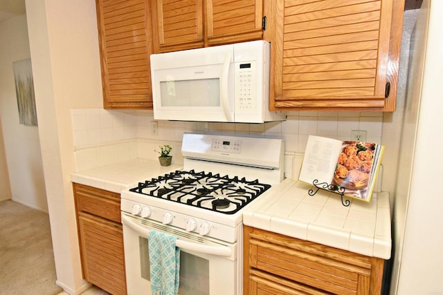 10908 Avenida Playa Veracruz, San Diego, CA 92124 - kitchen featuring white appliances, tile counters, tasteful backsplash, and light colored carpet