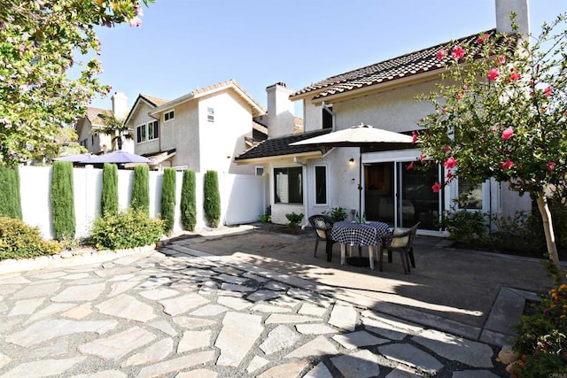 10908 Avenida Playa Veracruz, San Diego, CA 92124 - back of property with a patio area, stucco siding, a tile roof, and a chimney