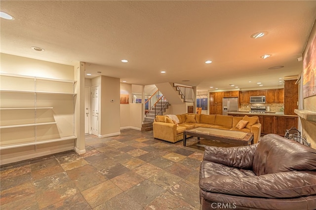 28367 Mount Stephen Ave, Canyon Country, CA 91387 - living room with stairway, recessed lighting, stone tile floors, and a textured ceiling