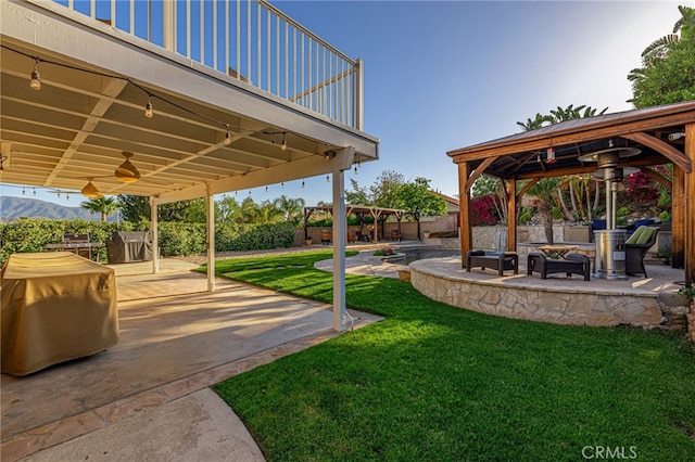 28367 Mount Stephen Ave, Canyon Country, CA 91387 - view of grassy yard featuring a gazebo, an outdoor fire pit, a patio, and ceiling fan