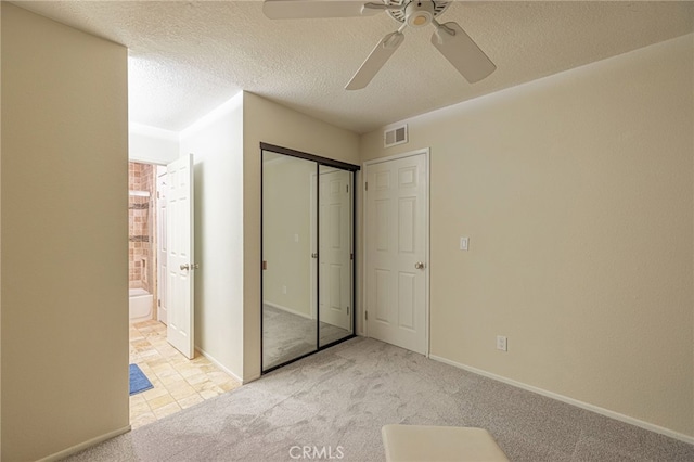 28367 Mount Stephen Ave, Canyon Country, CA 91387 - unfurnished bedroom featuring carpet floors, ensuite bathroom, a closet, a ceiling fan, and a textured ceiling