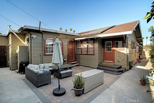 3031 4th Ave, Los Angeles, CA 90018 - rear view of property with an outdoor living space, solar panels, and a patio