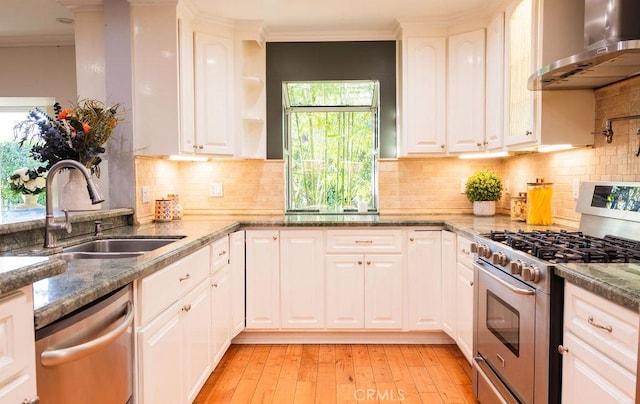 14816 Covello St, Van Nuys, CA 91405 - kitchen featuring appliances with stainless steel finishes, wall chimney range hood, a sink, ornamental molding, and plenty of natural light