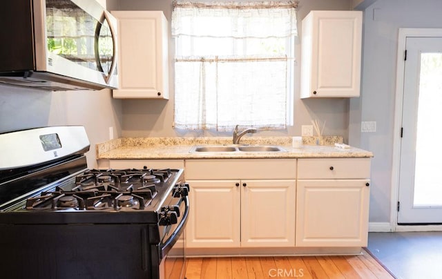14816 Covello St, Van Nuys, CA 91405 - kitchen with stainless steel appliances, a sink, and white cabinetry