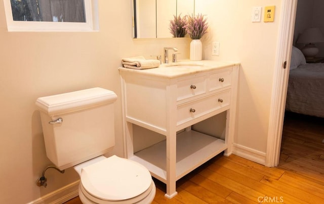 14816 Covello St, Van Nuys, CA 91405 - half bathroom featuring toilet, wood finished floors, vanity, ensuite bathroom, and baseboards