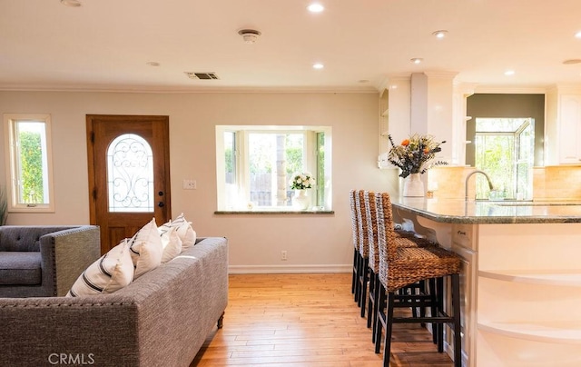 14816 Covello St, Van Nuys, CA 91405 - living area with plenty of natural light, light wood-type flooring, baseboards, crown molding, and recessed lighting