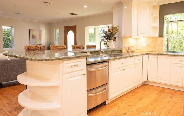 14816 Covello St, Van Nuys, CA 91405 - kitchen with open shelves, a sink, light wood-style floors, a peninsula, and light stone counters
